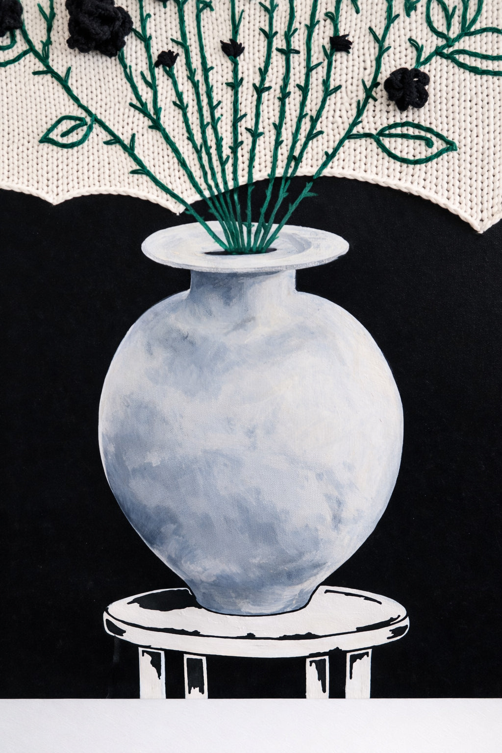 acrylic painted vase and black background beneath textile floral arrangement