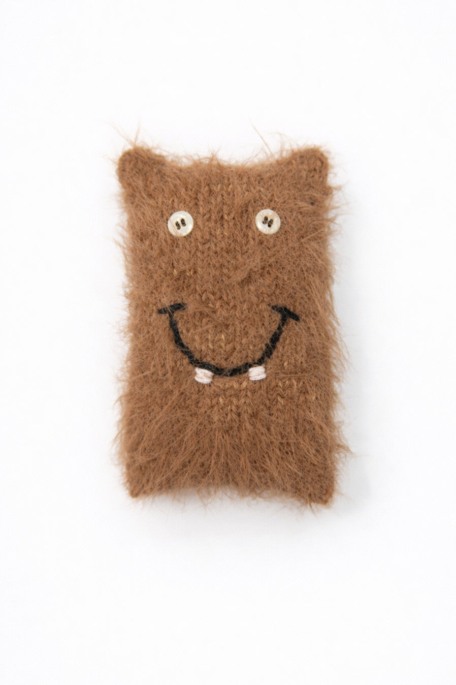 Handmade fuzzy monster baby toy with button eyes and smile in recycled cotton