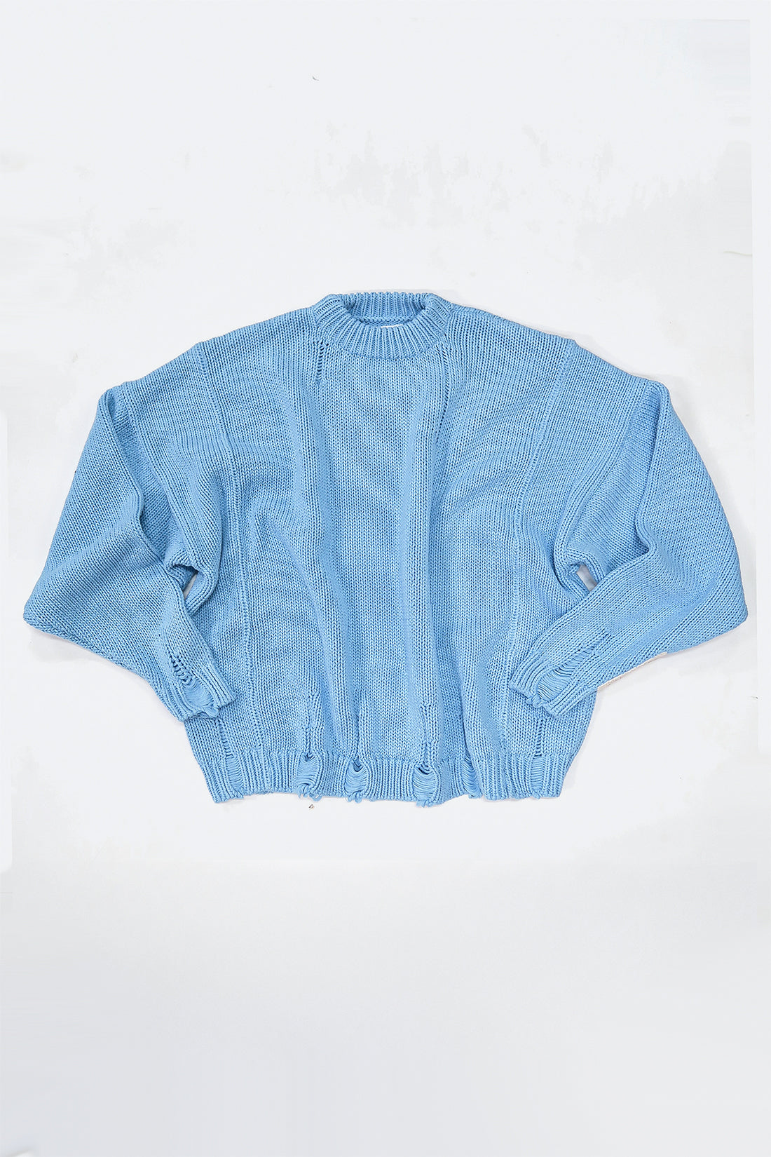 Relaxed flatlay of oversized blue knit sweater with wide body and slouchy fit