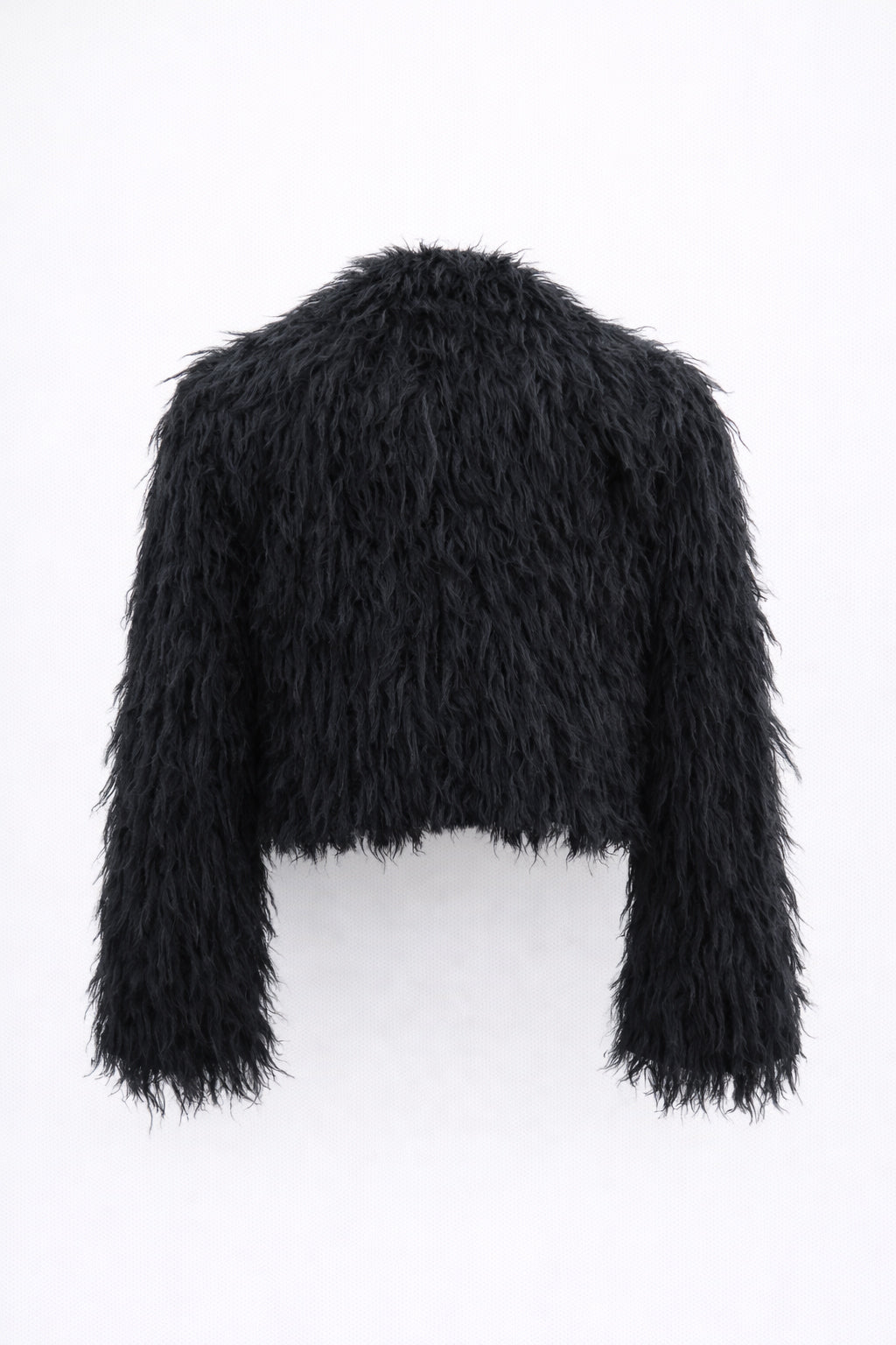 Back view of black cropped fringe jacket with hand loomed knit base and layered viscose fringe texture