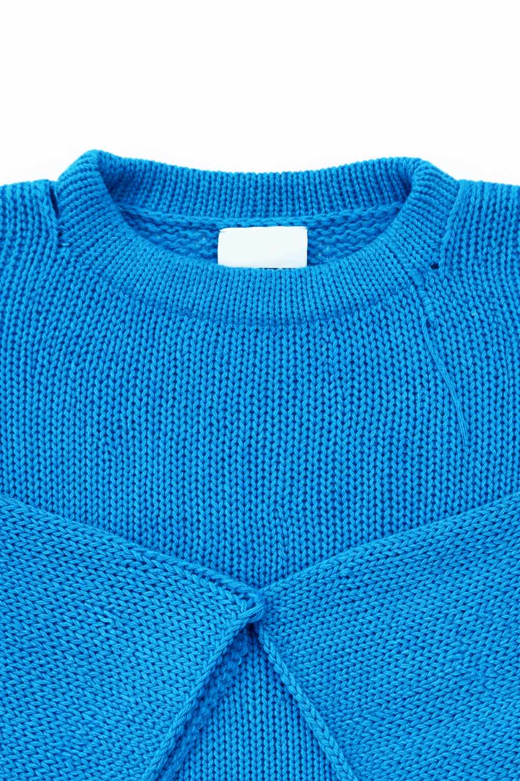 Neckline detail of cotton hand loomed lightweight turquoise sweater