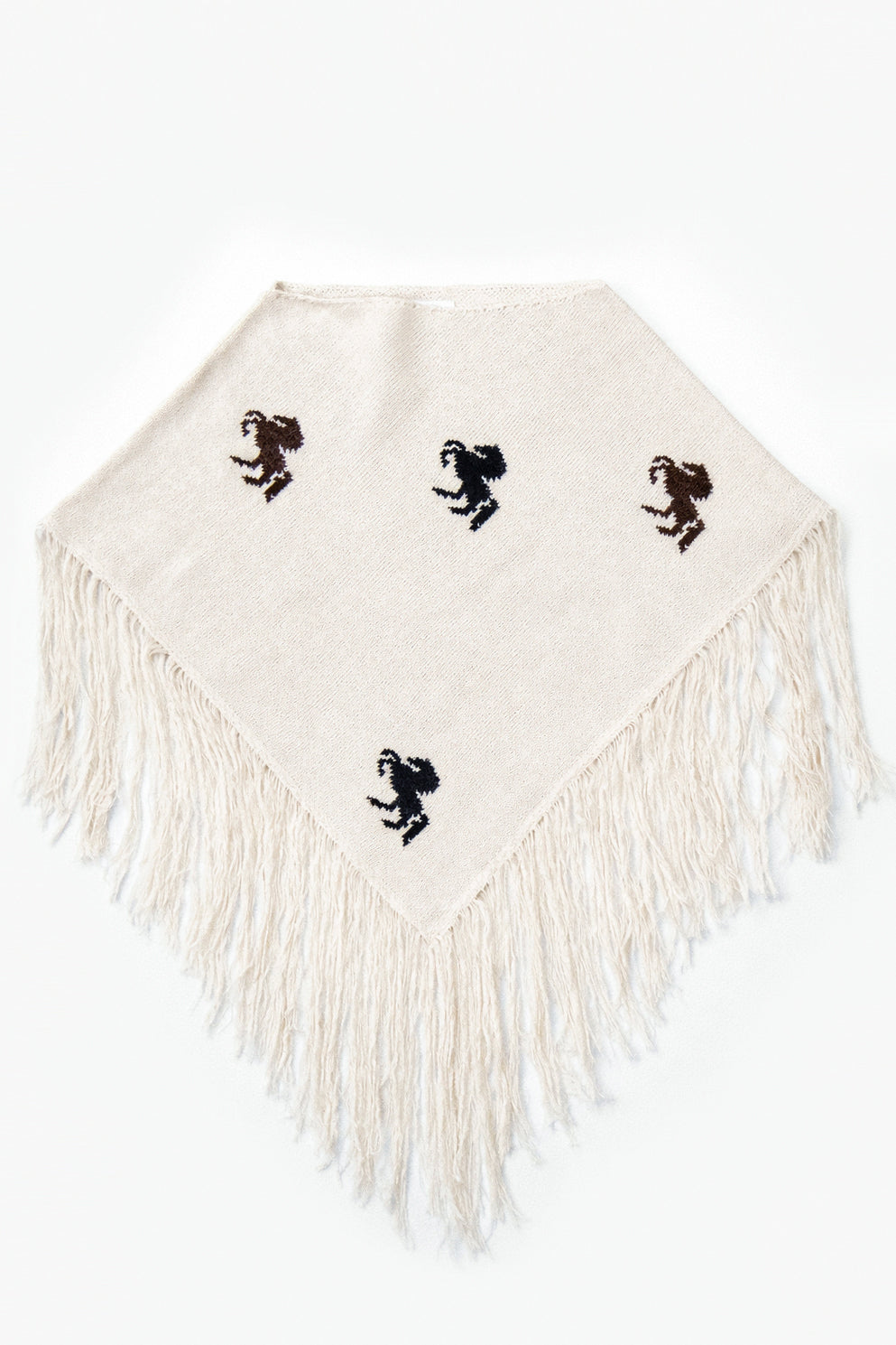 A cropped poncho knit in recycled cotton, cream base with brown and black horse motifs and long fringe