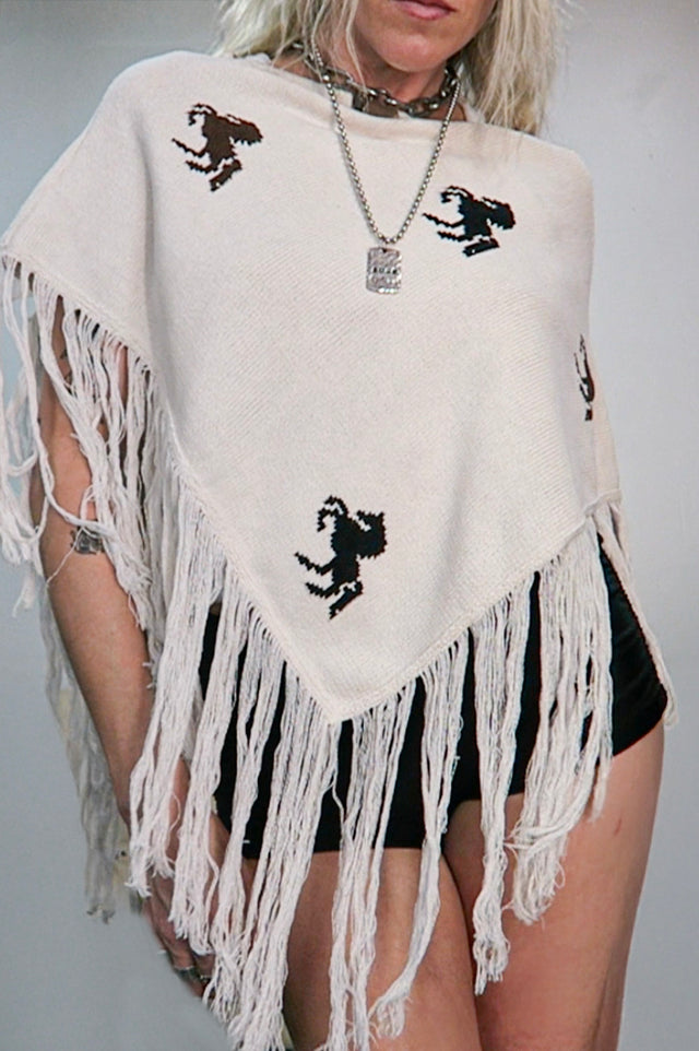 Cream cotton horse motif poncho with long fringe hand loomed in Los Angeles.