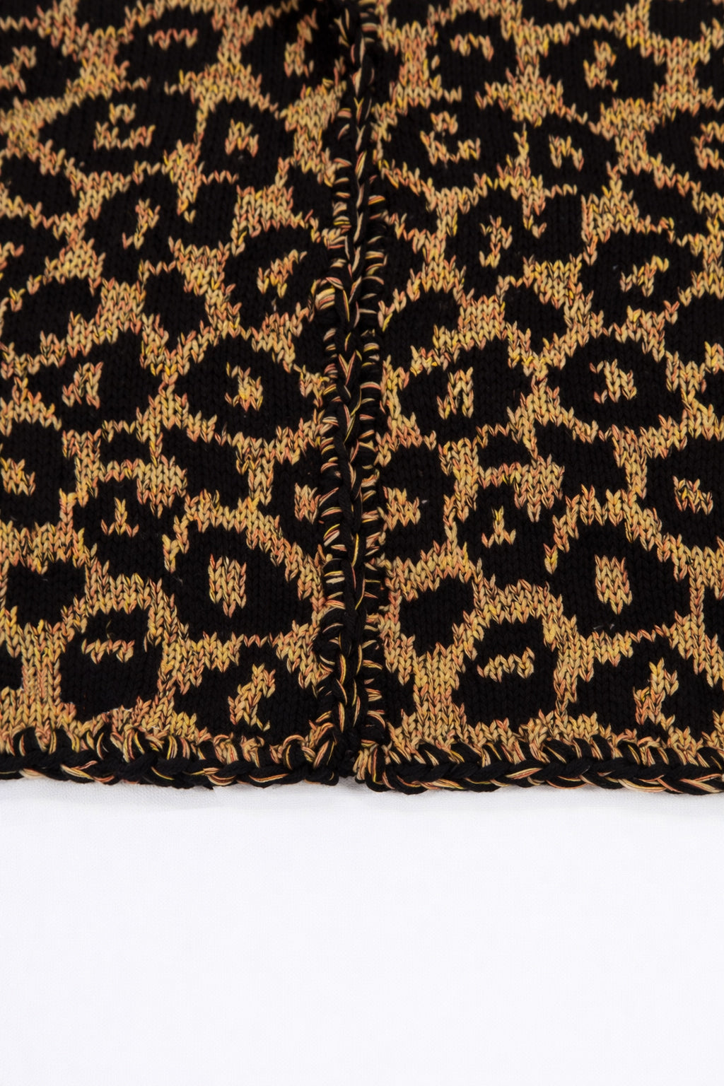 Crochet edge detail on leopard knit cardigan with textured yarn finish