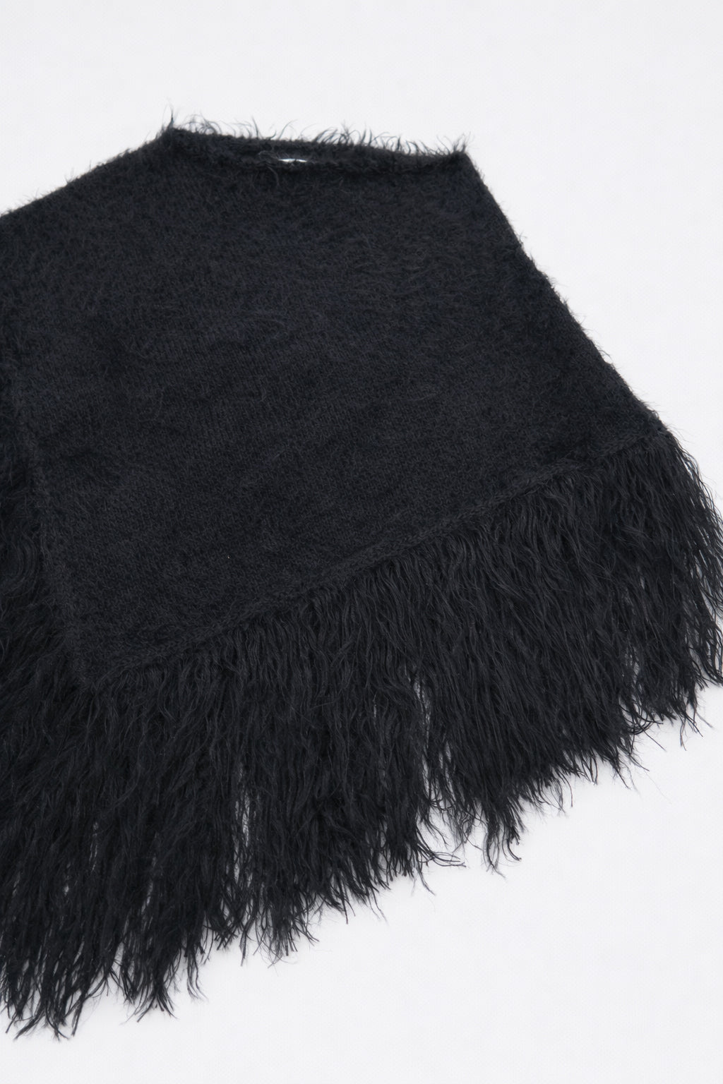 Black fuzzy cotton viscose knit poncho texture detail at angle shape