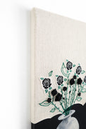 left top angled view of mixed media textile wall art combining knit, embroidery, and painting