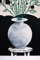 acrylic painted vase and black background beneath textile floral arrangement