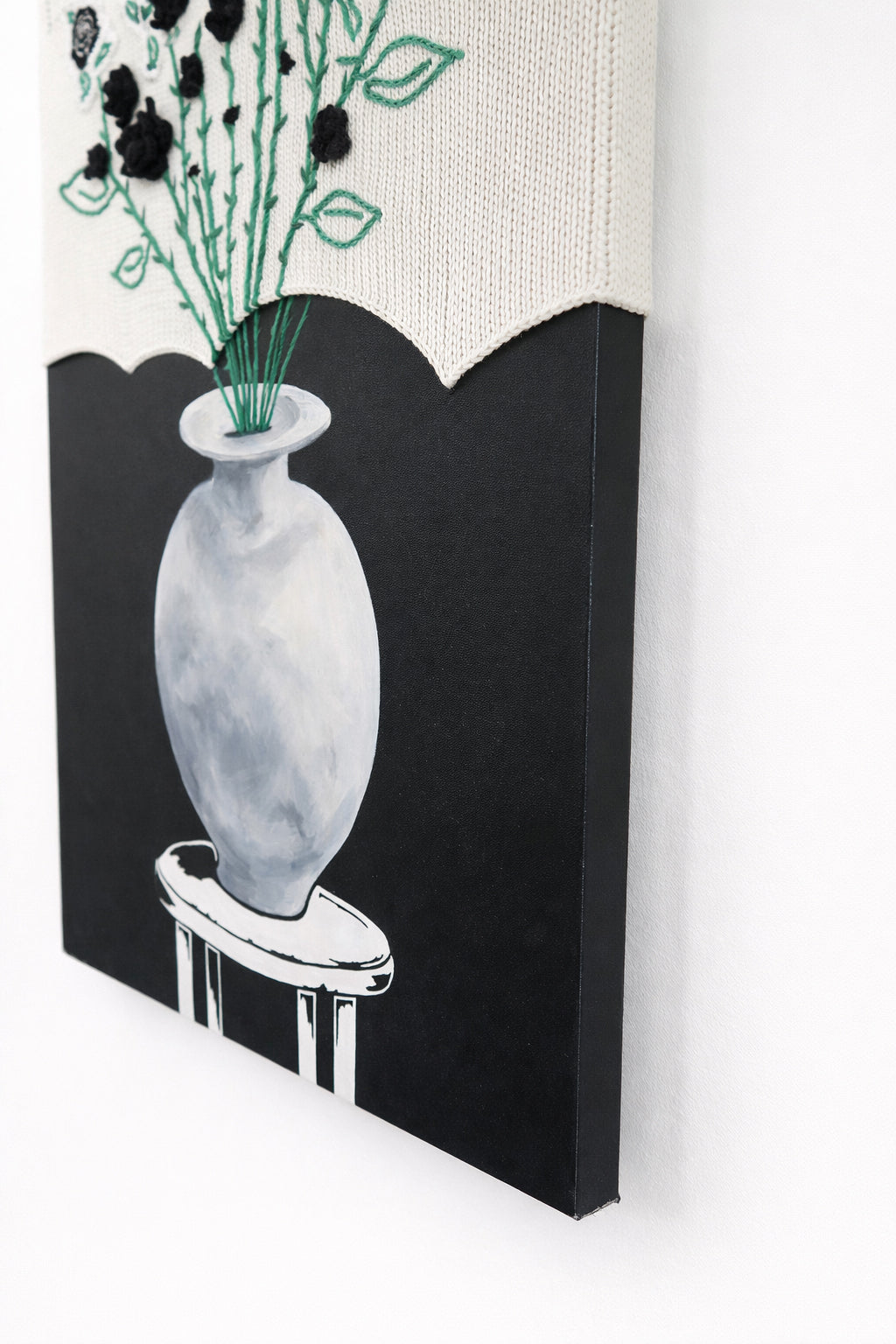 right bottom angled view of mixed media textile wall art combining knit, embroidery, and painting