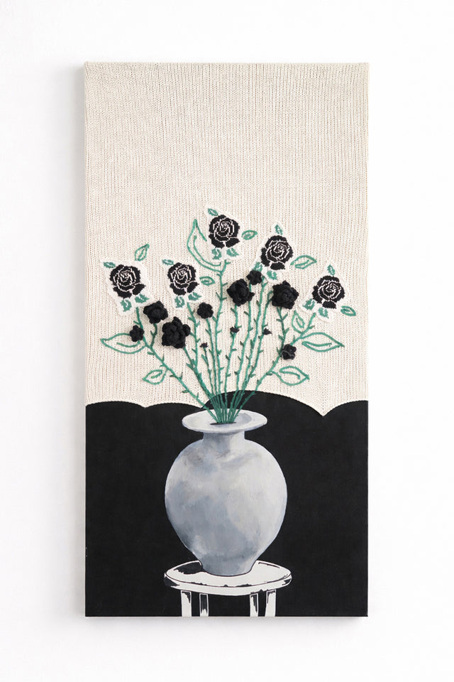 Suss Knits black rose textile wall art with hand loomed cotton knit panel, crocheted roses, and painted still life vase, 24x48 inches