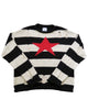 Black and white striped cotton sweater with a large red intarsia star on the front. All the edges of this sweater are rolled and it features tattered drop stitches all over. 