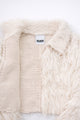 Close-up of hand loomed cotton knit base open front with layered cream viscose fringe detailing