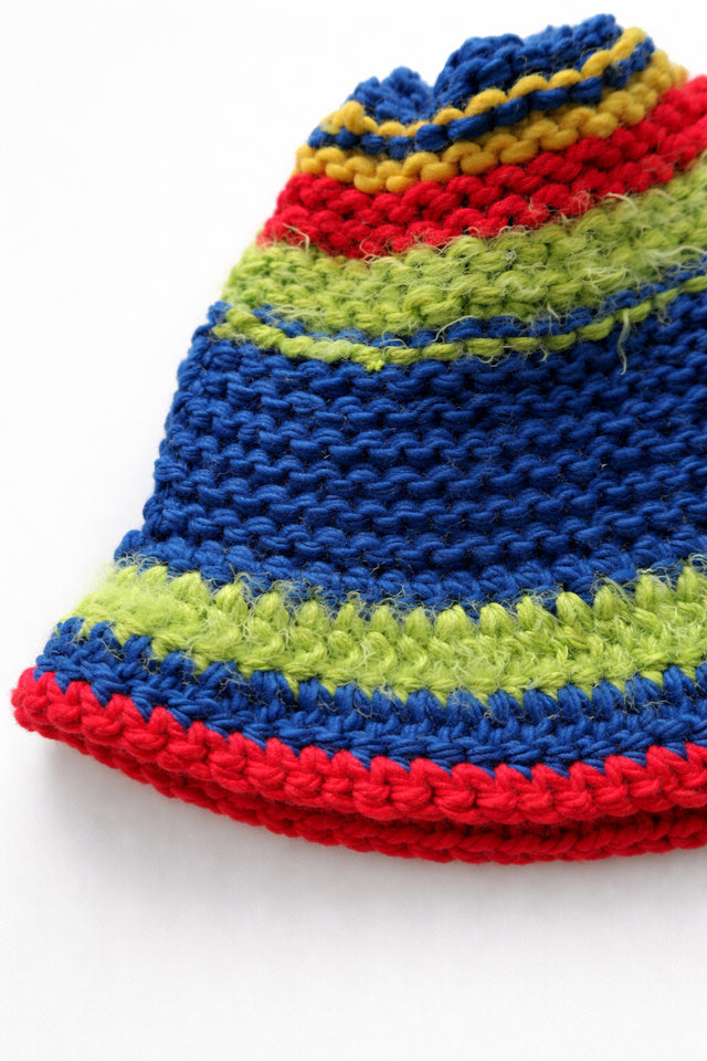 Close-up of multicolor hand knit bucket hat showing textured wool blend stitches and yarn detail