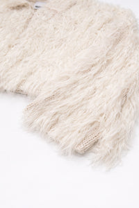 Close-up of dense cream fringe texture sleeve angle view on hand loomed cropped jacket