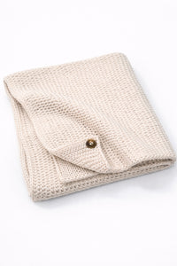 Cream cotton hand loomed baby blanket with textured stitch and soft finish