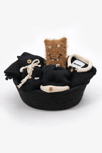 Handmade baby gift set knit in hand loomed cotton in black and cream in basket with beanie, cardigan, blanket, booties and soft toy