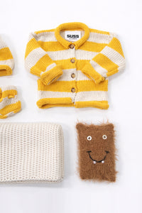 Close up of cotton yellow and cream striped baby cardigan knit texture detail