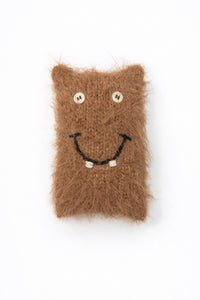 Handmade fuzzy monster baby toy with button eyes and smile in recycled cotton