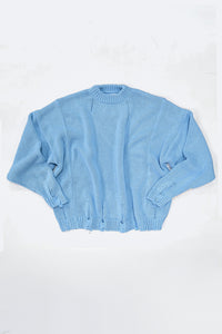 Relaxed flatlay of oversized blue knit sweater with wide body and slouchy fit