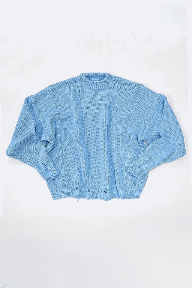 Relaxed flatlay of oversized blue knit sweater with wide body and slouchy fit