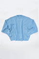 Relaxed flatlay of oversized blue knit sweater with wide body and slouchy fit