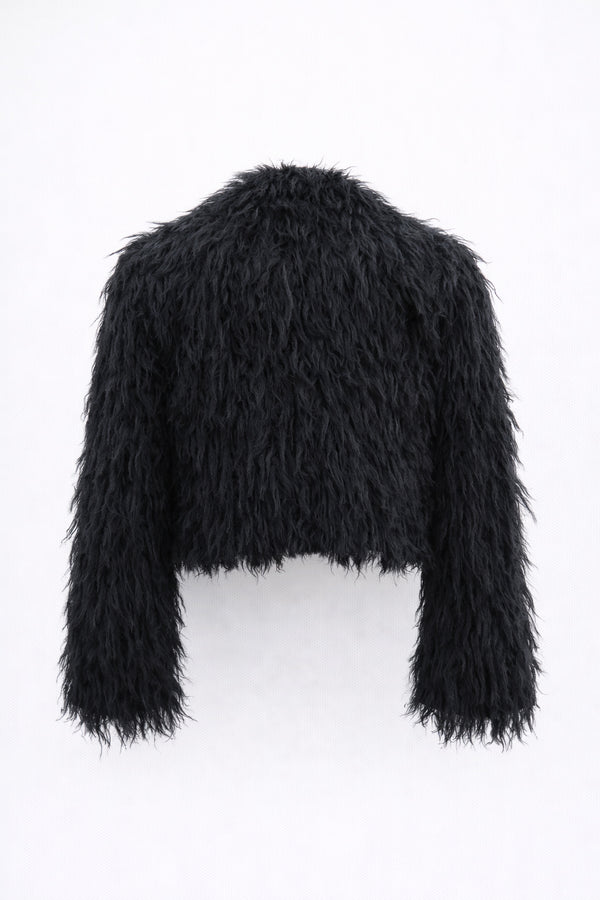 Back view of black cropped fringe jacket with hand loomed knit base and layered viscose fringe texture