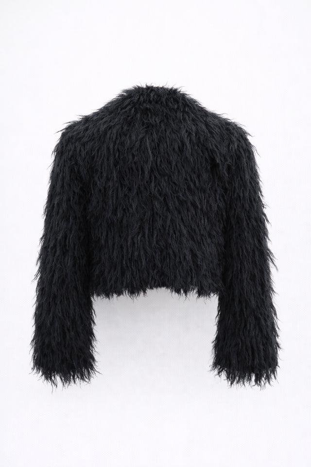 Back view of black cropped fringe jacket with hand loomed knit base and layered viscose fringe texture