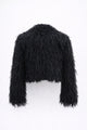 Back view of black cropped fringe jacket with hand loomed knit base and layered viscose fringe texture