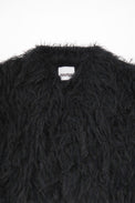 Close-up of dense black fringe texture on hand loomed cropped jacket