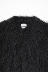 Close-up of dense black fringe texture on hand loomed cropped jacket