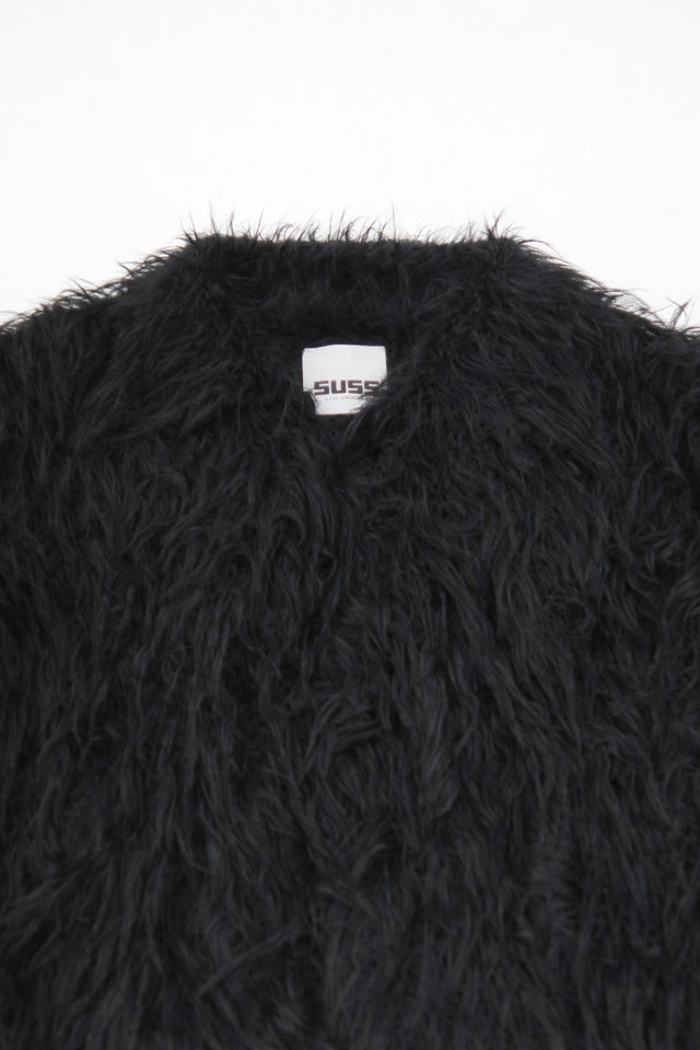 Close-up of dense black fringe texture on hand loomed cropped jacket