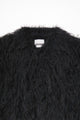 Close-up of dense black fringe texture on hand loomed cropped jacket