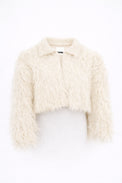 Cropped cream fringe jacket shown on form, featuring hand loomed cotton knit base with long shaggy fringe