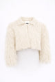 Cropped cream fringe jacket shown on form, featuring hand loomed cotton knit base with long shaggy fringe