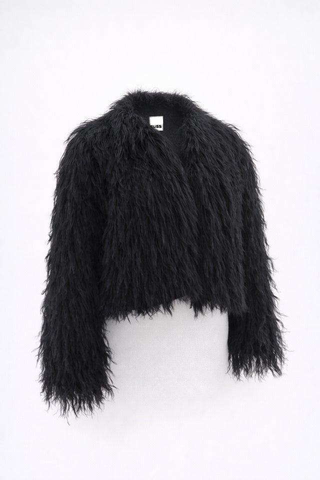 Cropped black fringe jacket shown on form, featuring hand loomed cotton knit base with long shaggy fringe