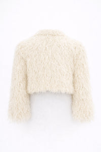 Back view of cream cropped fringe jacket with hand loomed knit base and layered viscose fringe texture