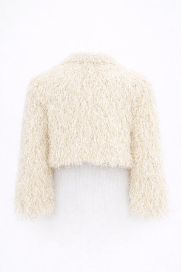 Back view of cream cropped fringe jacket with hand loomed knit base and layered viscose fringe texture