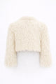 Back view of cream cropped fringe jacket with hand loomed knit base and layered viscose fringe texture