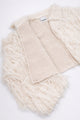 Detailed view of cream fringe knit jacket showing contrast between structured knit inside and soft fringe at angle