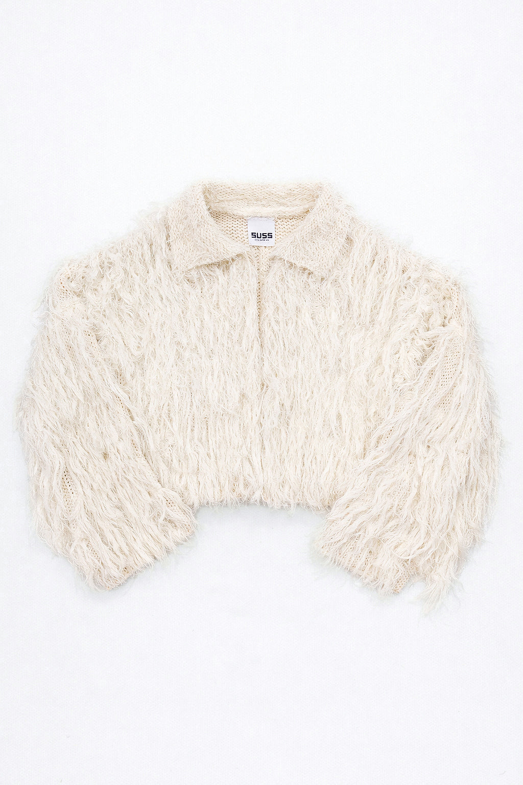 Cream hand loomed cropped cotton jacket with long viscose fringe knit in a textured knit construction