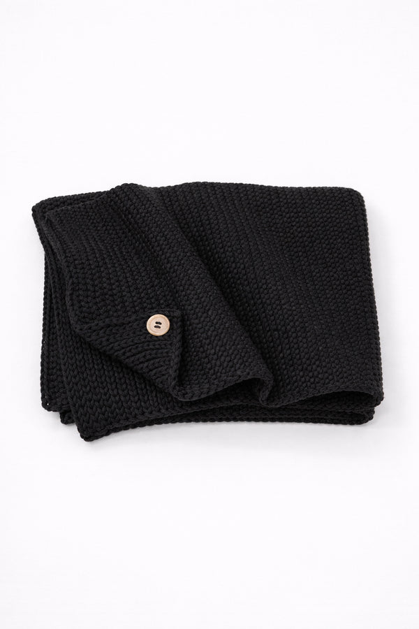 Hand loomed cotton black baby blanket with textured stitch and raw edge detail