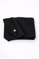 Hand loomed cotton black baby blanket with textured stitch and raw edge detail