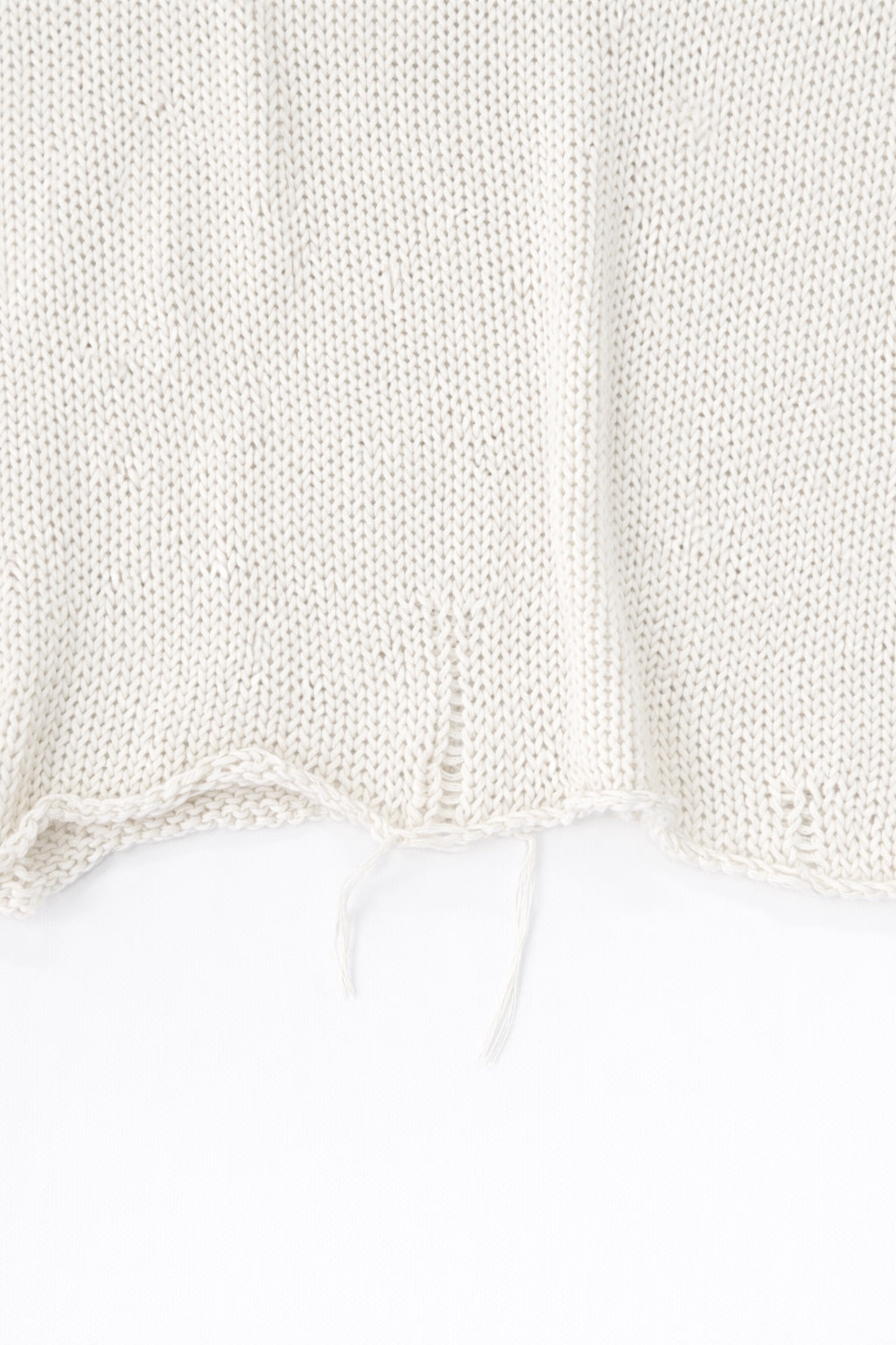 Raw edge hem detail of cream cotton light weight knit sweater by Suss Knits