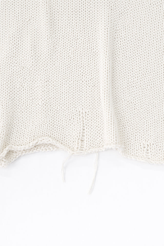 Raw edge hem detail of cream cotton light weight knit sweater by Suss Knits