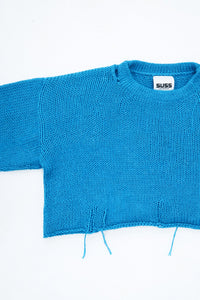 Armhole detail of soft cropped turquoise knit sweater