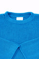 Neckline detail of cotton hand loomed lightweight turquoise sweater