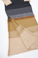 Close-up of Suss knit dress showing side slit and layered knit construction in neutral tones