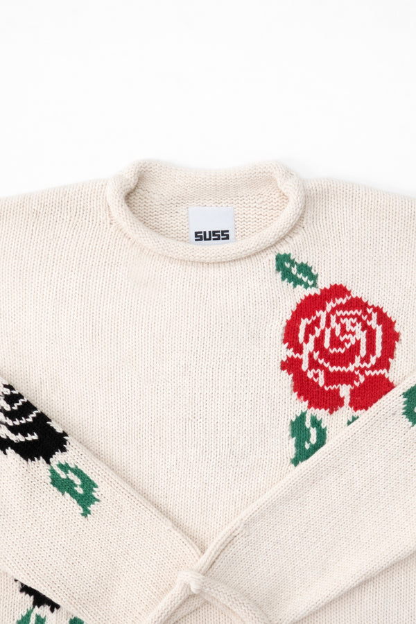 Neckline detail of the Suss rose intarsia rollneck swedater hand loomed in cream recycled cotton