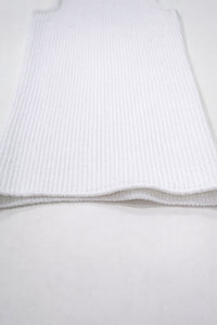 Flat lay detail of white knit tank hem showing textured ribbing and soft structure