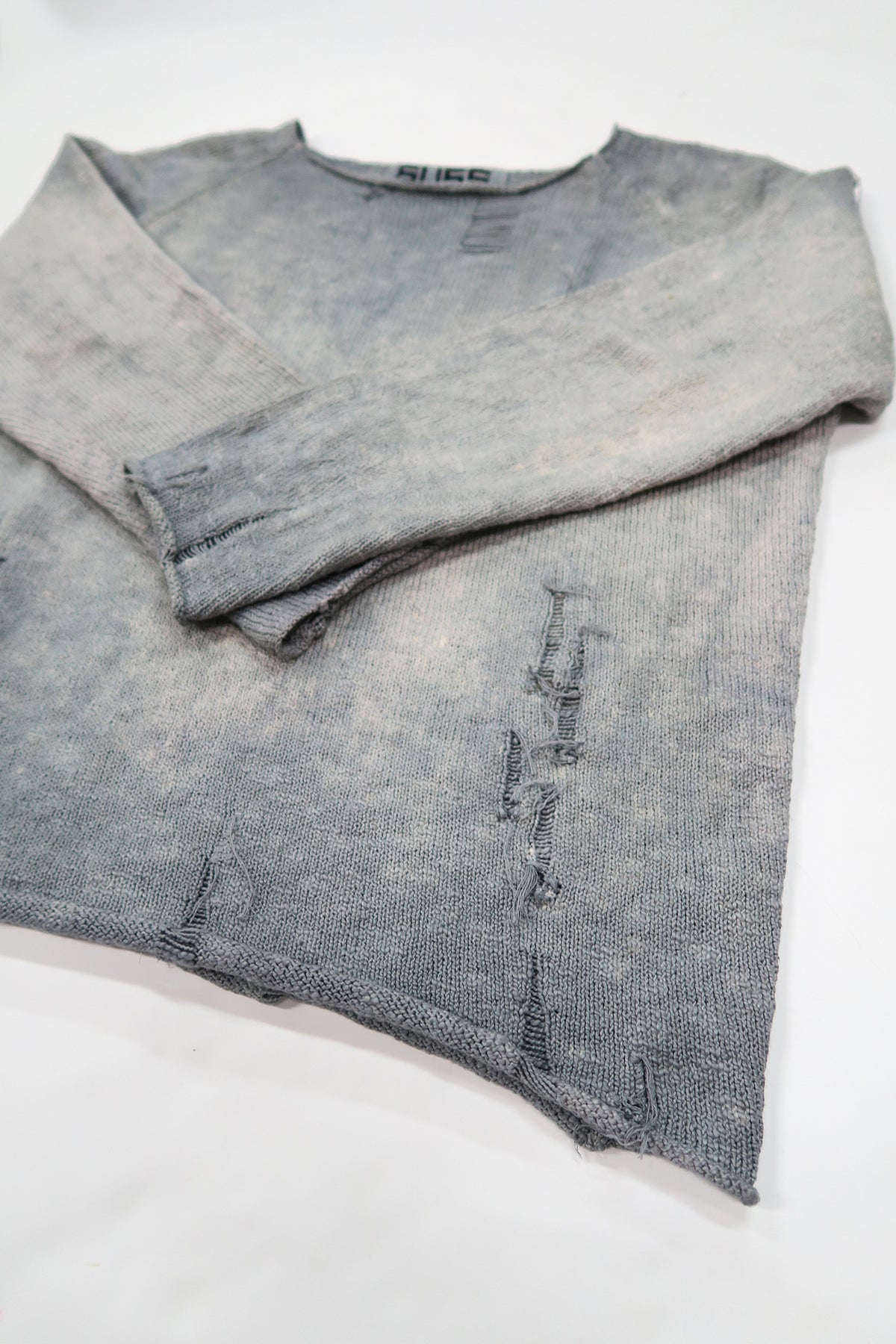 Suss Knits Archive Finish Raglan angled flat lay showing hand-dyed cotton knit and distressed details