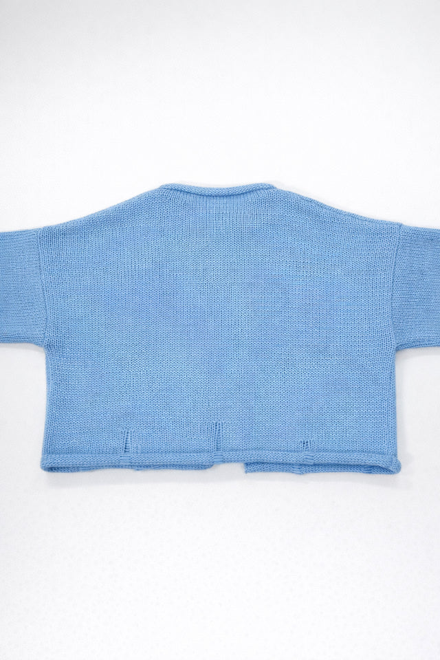 Back view of baby blue cotton cropped knit jacket by Suss Knits